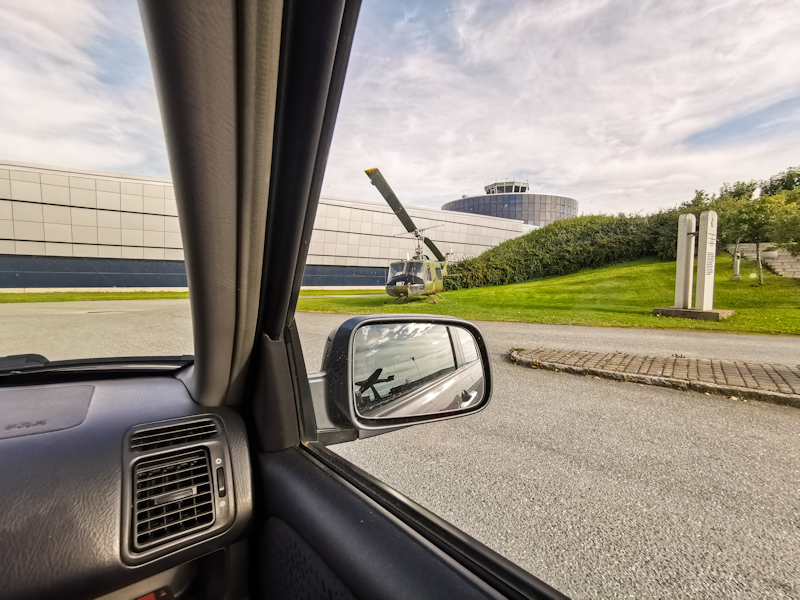 Aviation museum with a Huey helicopter and a Spitfire (?) in the rear mirror.