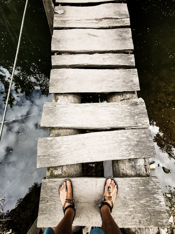 Me on a shaky bridge with my broken and fixed sandal.