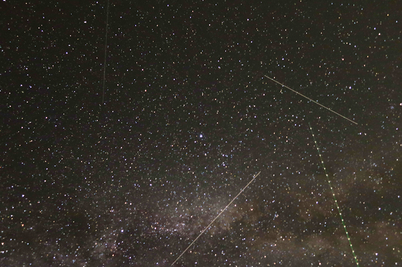 Busy night sky with the milky-way (bottom right), an aircraft with its strobe lights and two satellites maybe 