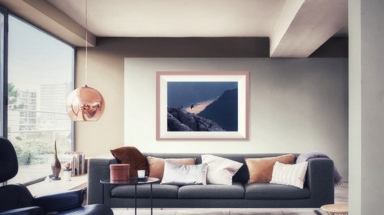 Color photo of a living room with a Delphicaphoto fine art print framed and hanging on the wall