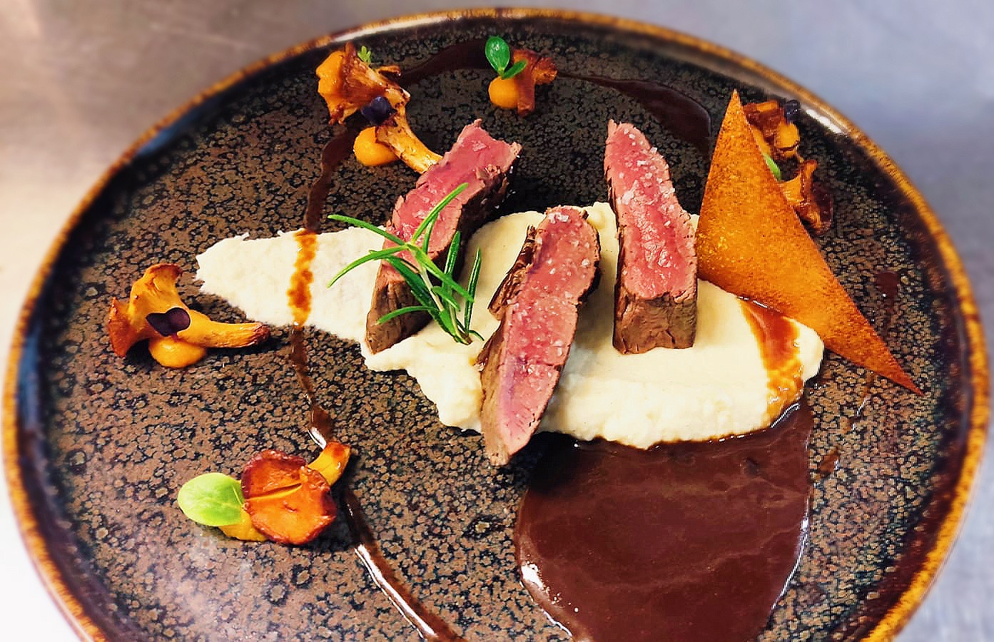 Rehrücken rosa gebraten auf Selleriemoussline mit Karottengel und gebratenen Pfifferlingen