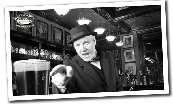 Polaroid of 'Inside a real pub' showing ZakWashington reaching across and pointing at a pint of stout beer.