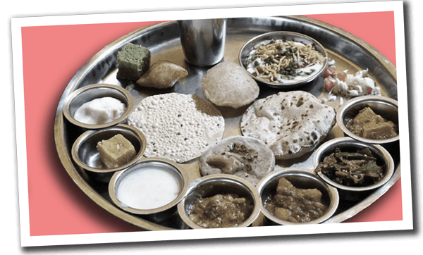 Polaroid-style photo of British-Indian food on a silver tray