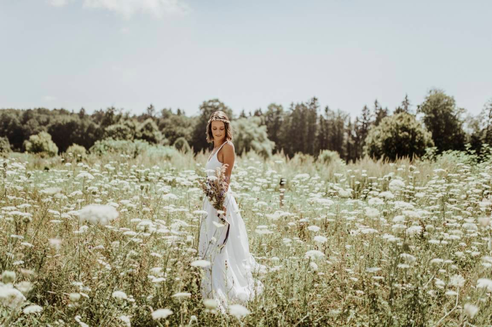 Dein großer Tag im Boho-Stil: Brautkleid Zweiteiler Inspiration: Eine inspirierende Aufnahme eines Boho Brautkleid Zweiteilers mit einem langen, fließenden Rock und einem romantischen Spitzen-Oberteil. Ideal für eine natürliche Hochzeitsfeier im Freien.