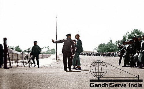 8 - Policeman confronting Mahatma Gandhi as he led the striking Indian mineworkers from Newcastle to the Transvaal (in protest of the Immigration Act), November 6, 1913.