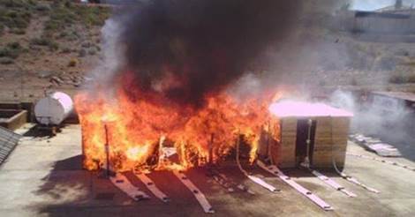 A fire experiment conducted on three timber structures of 3m x 3m in size showing large amounts of flaming and a fire tornado