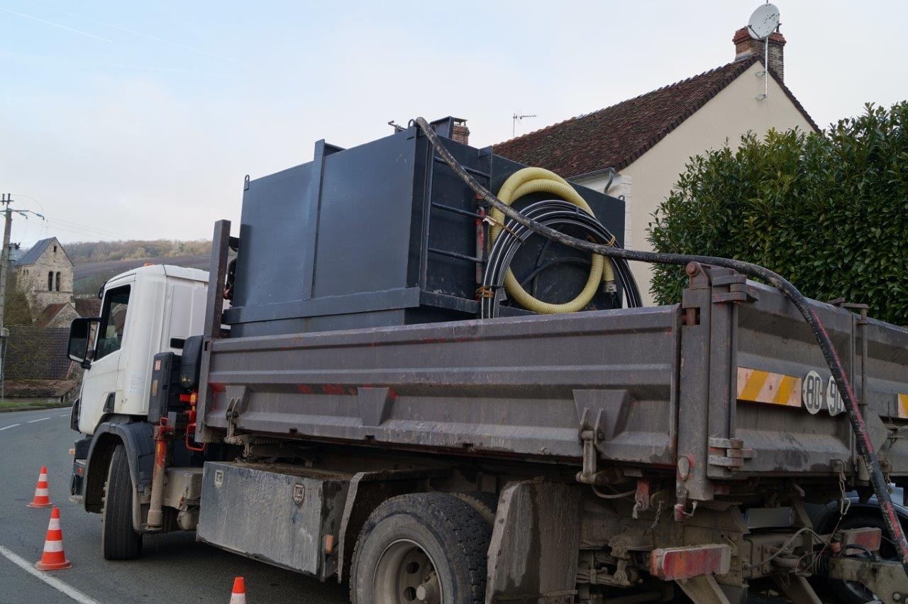 Un camion transporte un réservoir d'eau.