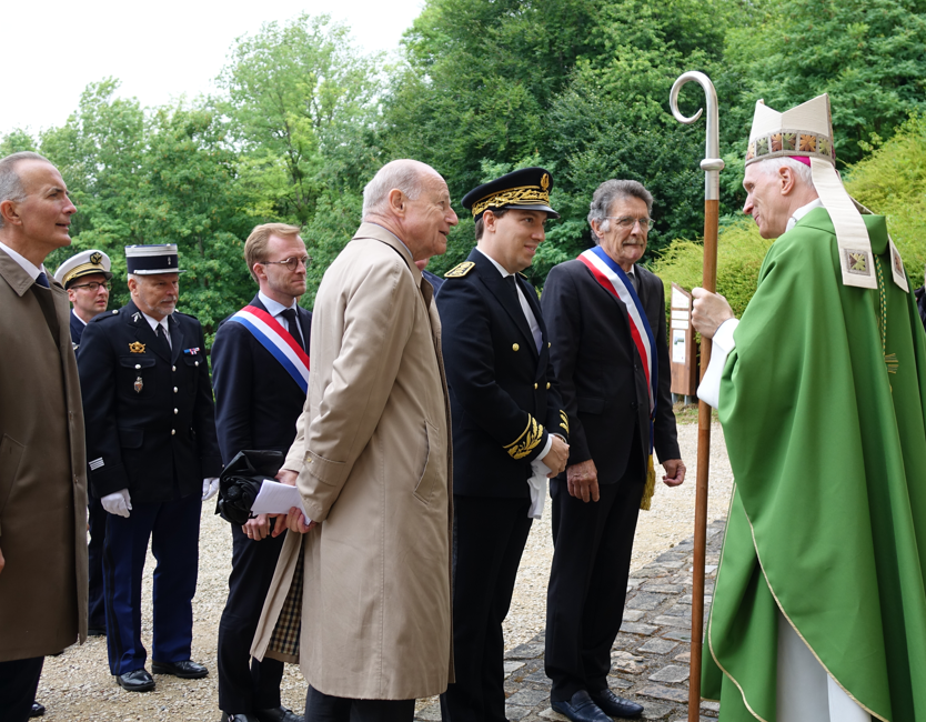 Mgr Franck Javary accueille les personnalités sur le parvis du mémorial.