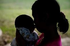 Pook, 14, with her 11-day-old baby at the Association for the Promotion of the Status of Women in Bangkok, on October 29, 2013   