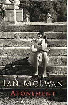 Photo of a young girl sitting on the steps leaning her head on he left hand, looking off to the side