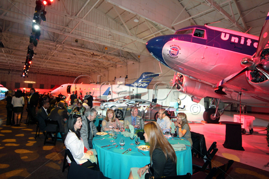 Dinner party at an airplane hangar.
