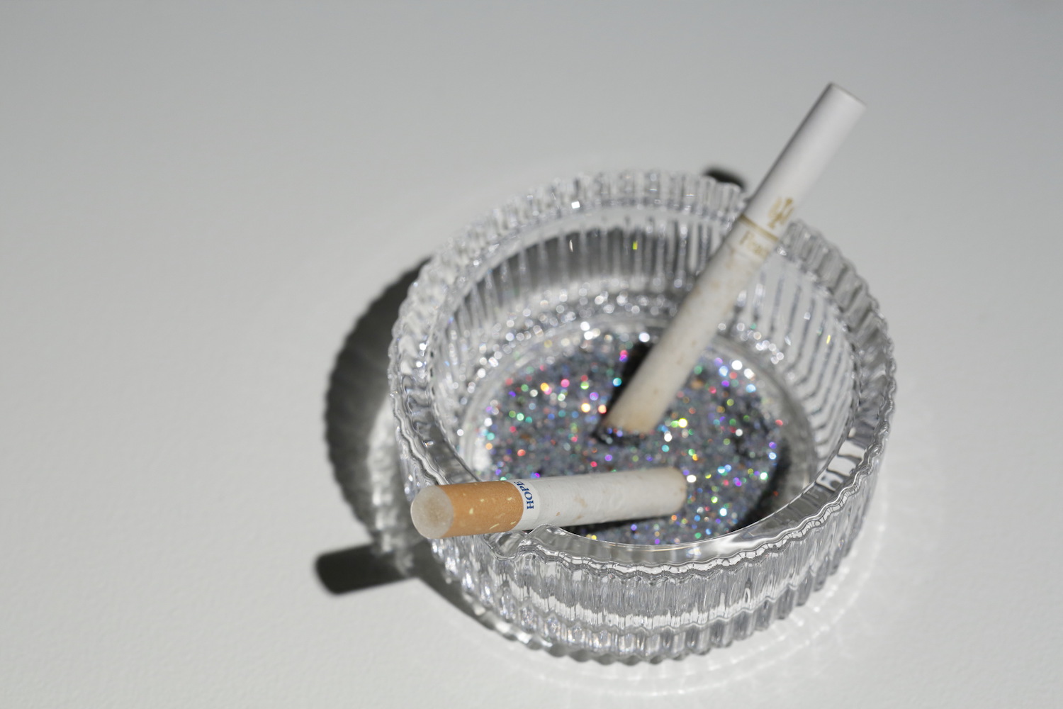 Our Hope, 2012, ashtray, cigarettes, glitter, ashes