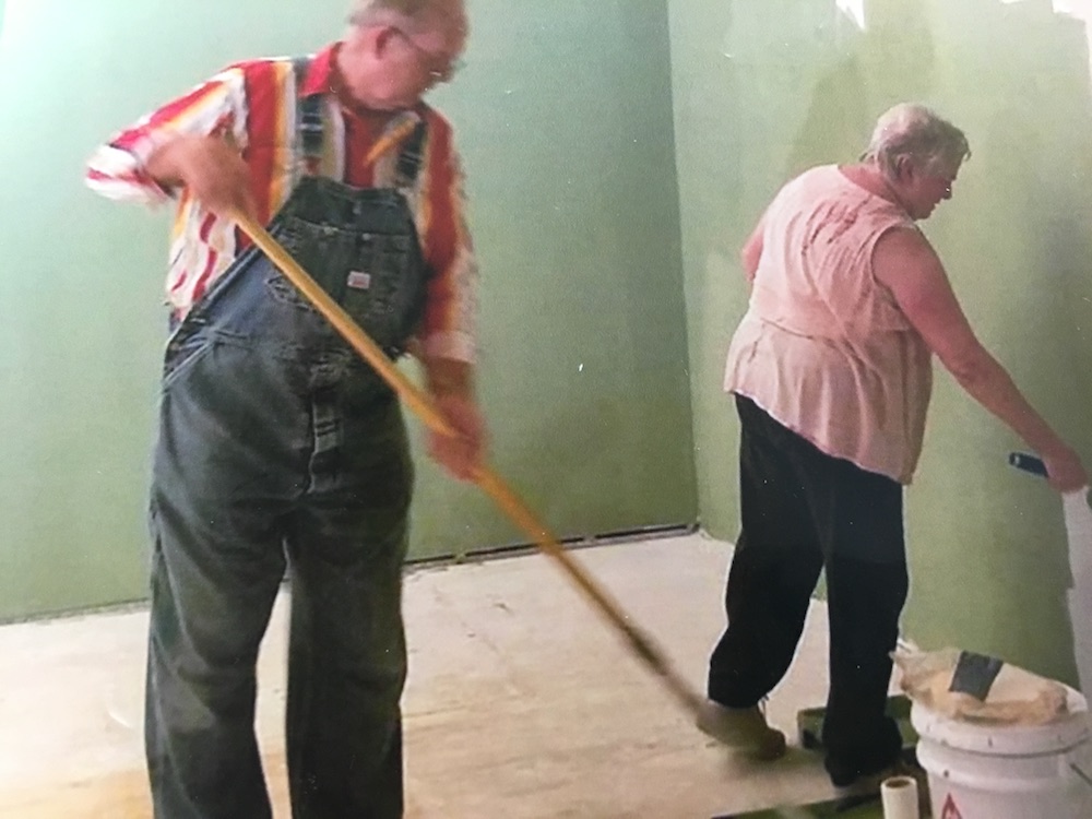 Wayne and Linda Bryan painting wall before flooring added, May 2017