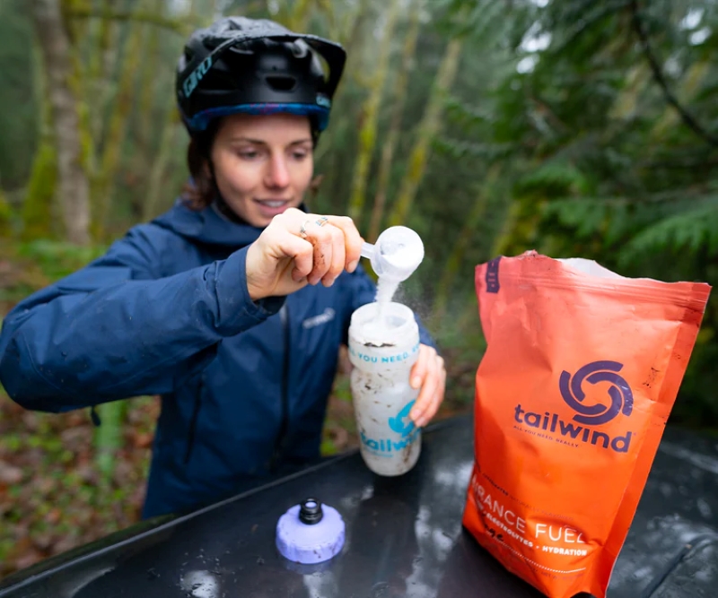a woman making her tailwind nutrition drink