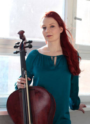 Cello player and composer Stefanie John from Berlin with her homemade red reverb cello Campanula