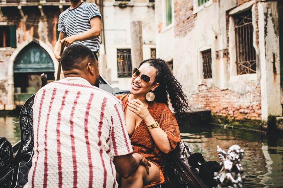 Man proposing to his partner on a gondola at sunset