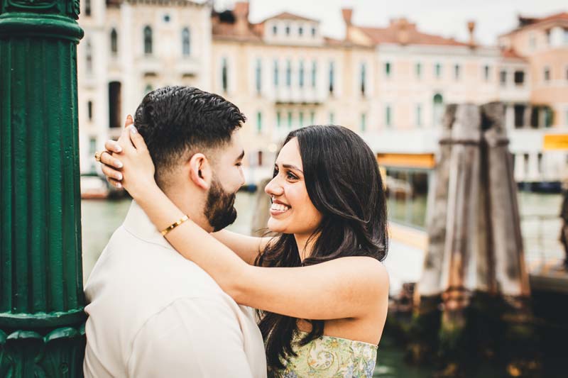 Professional Engagement photographer taking a photo of a couple in Venice