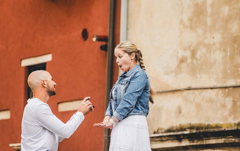 Liam kneeling on Ponte Chiodo during the Venice proposal story