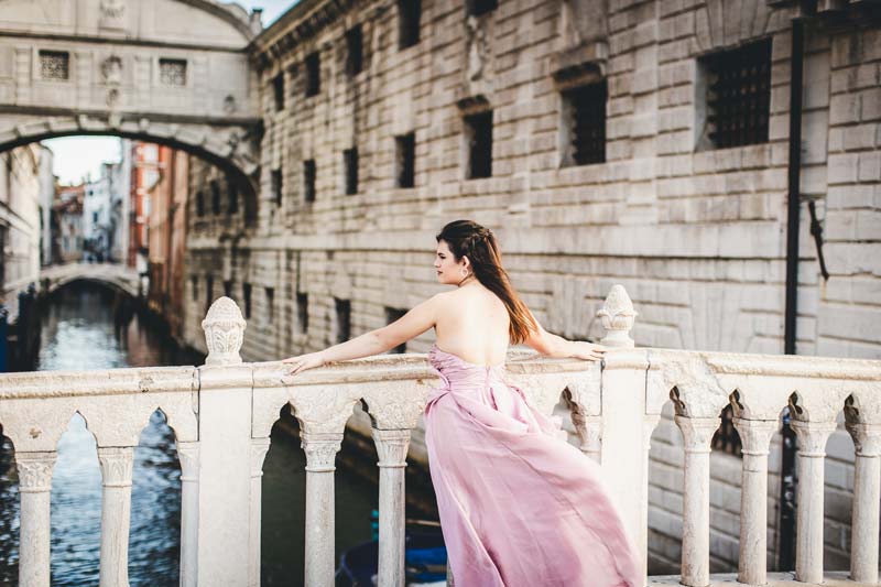Professional photographer capturing a Quinceañera in Venice with traditional fan and tiara