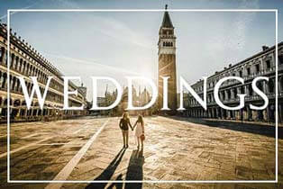 Professional Venice photographer capturing a couple walking through a quiet canal at sunrise.