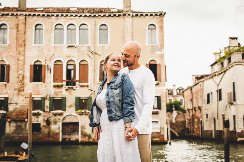 Couple laughing together during their walk through Venice