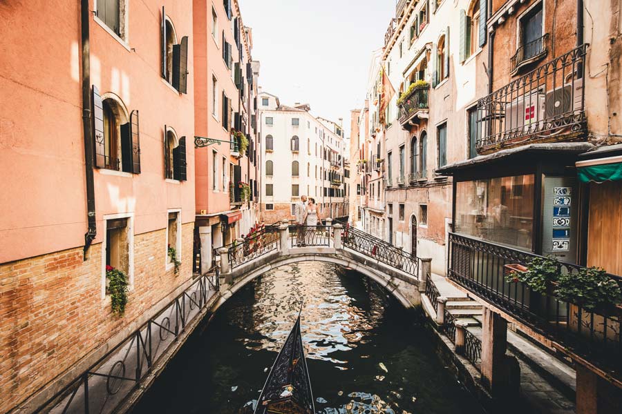 Classic Venetian architecture framing a wedding portrait