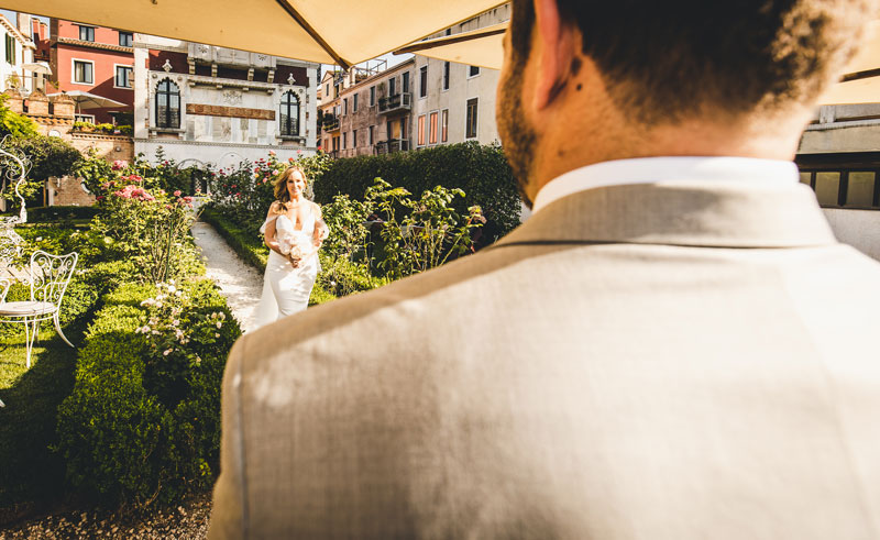 The couple exchanging their vows in the serene setting of the Ca' Nigra garden.