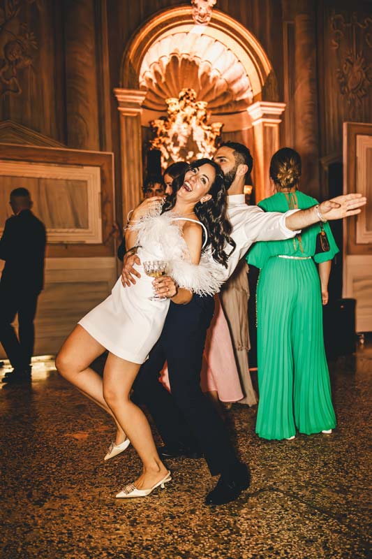 Guests dancing and celebrating during the party, Venice wedding night.