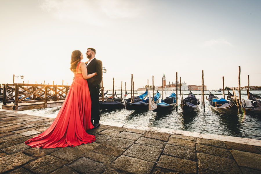 Elopement couple standing under archway with golden light filtering through