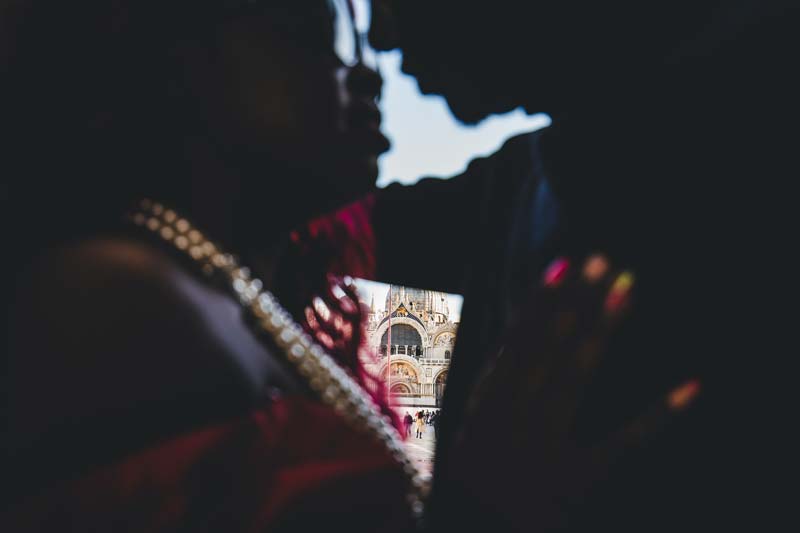 A detail shot of the couple's hands, with the engagement and wedding rings in clear focus.