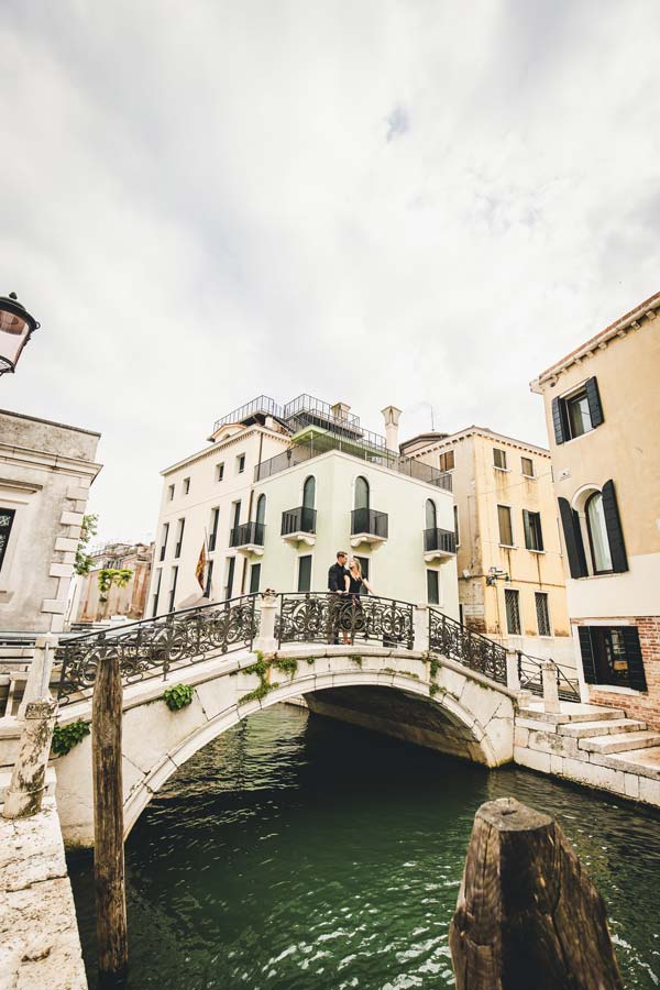 Couple walking at Punta della Dogana during sunset in Venice