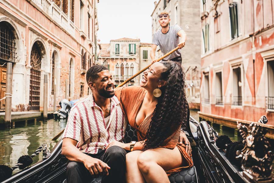 Newly engaged couple embracing on a gondola in Venice