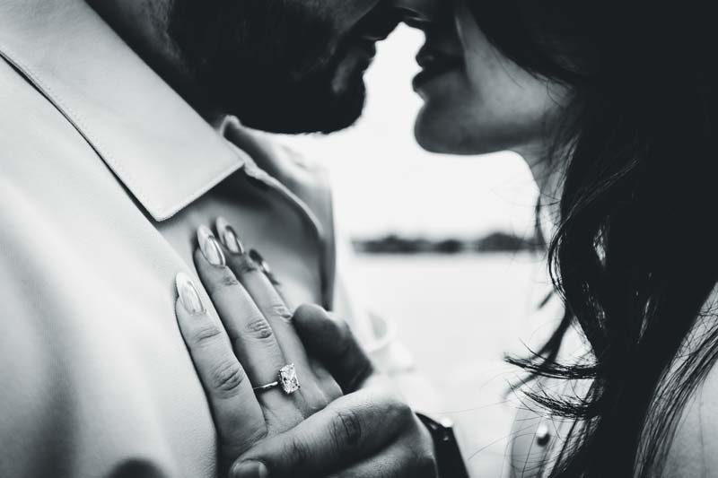 Close-up of a diamond engagement ring with Venice canals in the background.