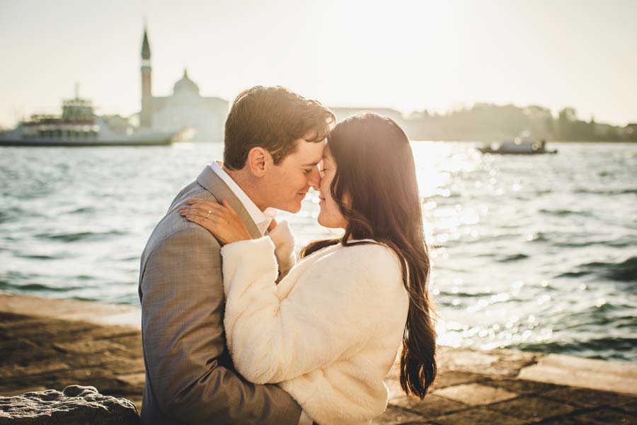 natural engagement moment in Venice with gondolas in the background