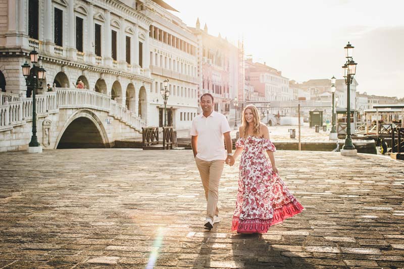 Family portrait with gondolas in the background at sunrise in Venice