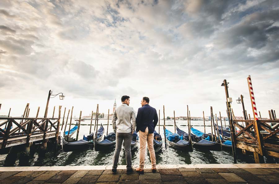 Backlit silhouette of a same-sex couple during Venice sunrise shoot