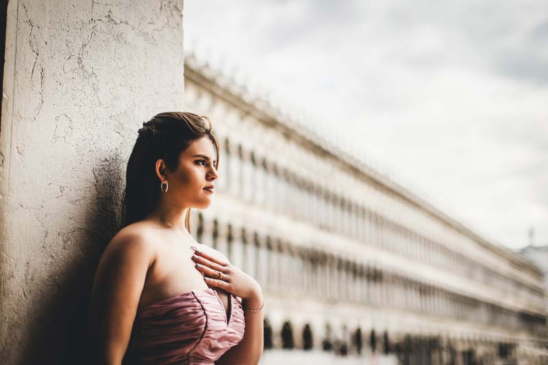 Detail shot of a Quinceañera dress and bouquet on a marble balcony in Venice