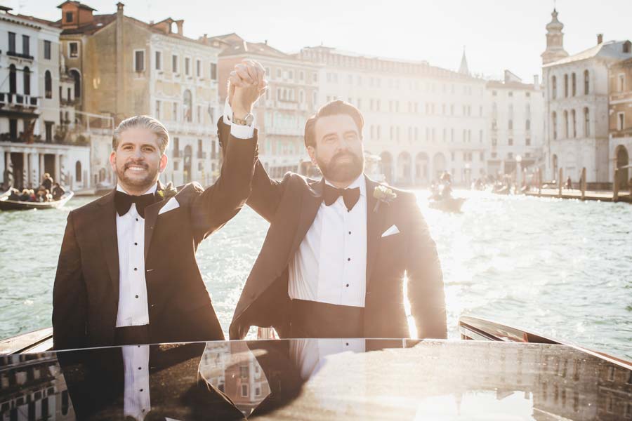 LGBTQ+ couple enjoying a private water taxi ride along the Grand Canal after their elopement