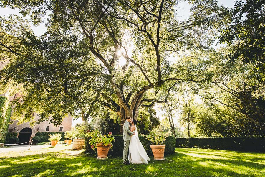 Wedding toast moment with guests celebrating in Castello di San Fabiano reception area