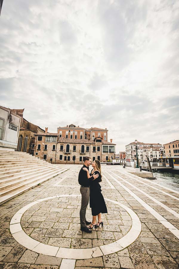 Couple walking at Punta della Dogana during sunset