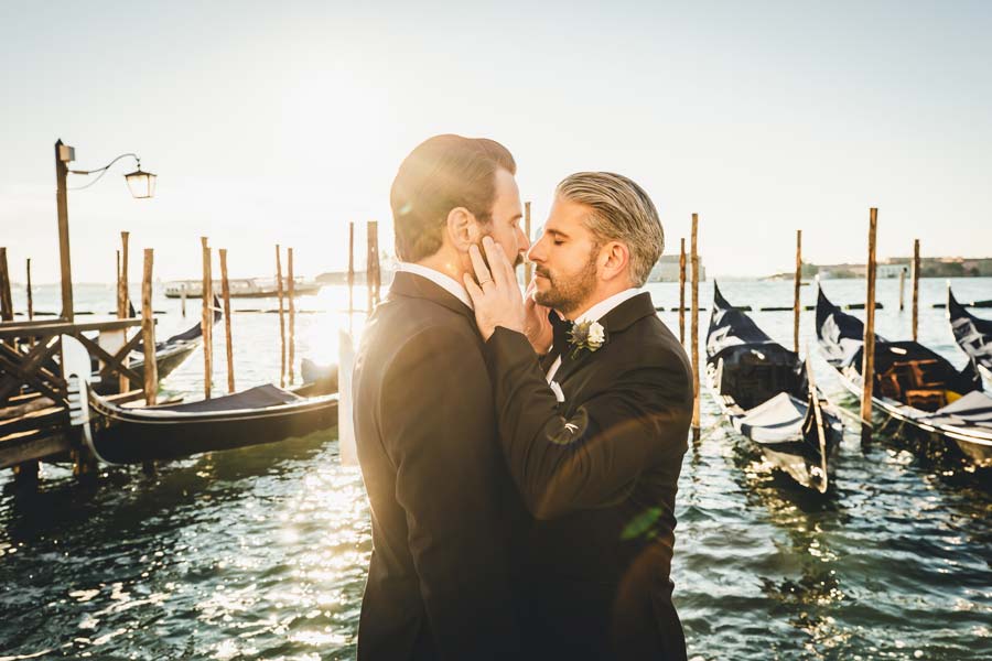 Romantic Venice elopement shoot with golden sunrise light reflecting on the water.
