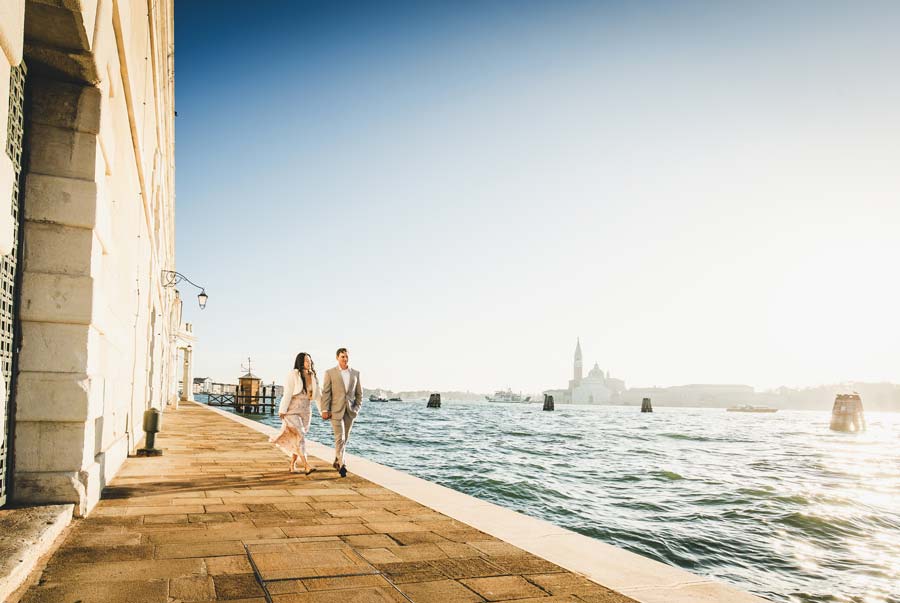 couple holding hands during engagement session in Venice narrow street