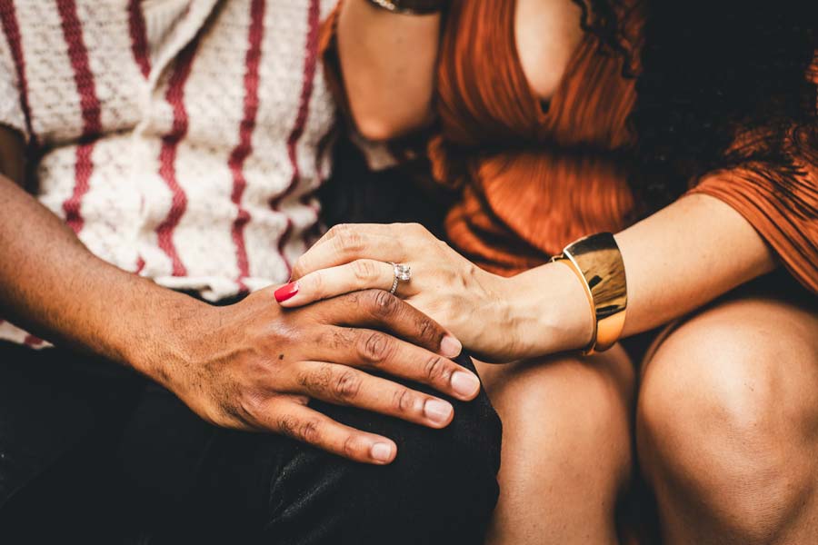 Close-up of hands with engagement ring against the Venice skyline