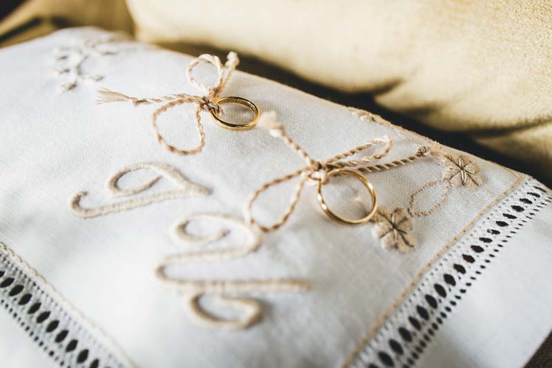 Close-up of the wedding rings placed on a velvet cushion