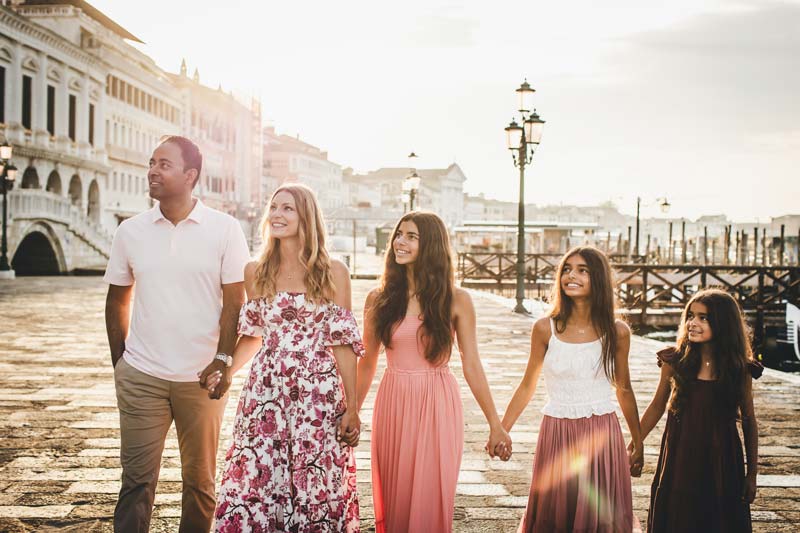 Candid moment of parents watching their kids play in Venice
