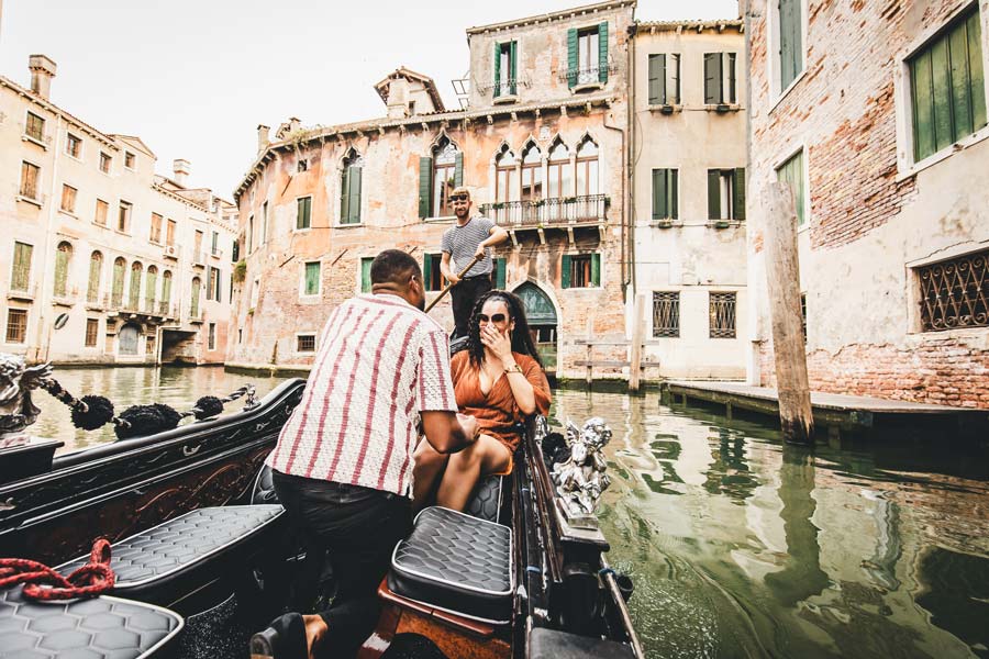 Couple celebrating a surprise proposal on a Venice gondola