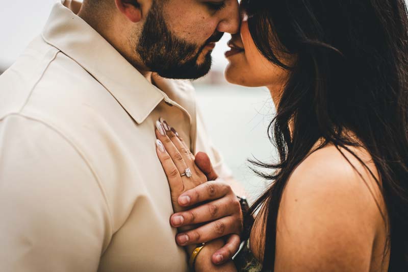 Joyful moment from a Venice engagement photoshoot with the couple embracing.