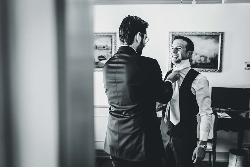 Groom adjusting his suit before the ceremony, Hotel Monaco wedding.