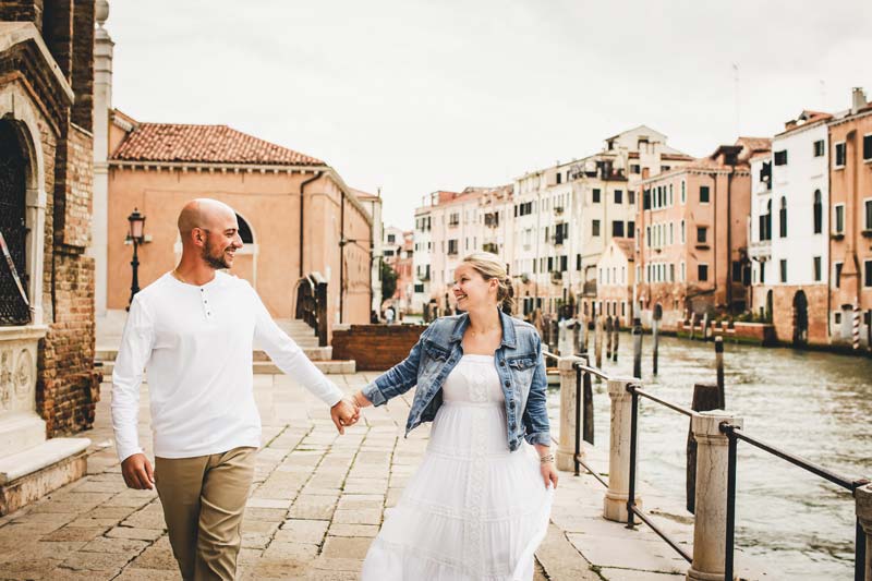 Soft winter light illuminating the couple during their Venice story