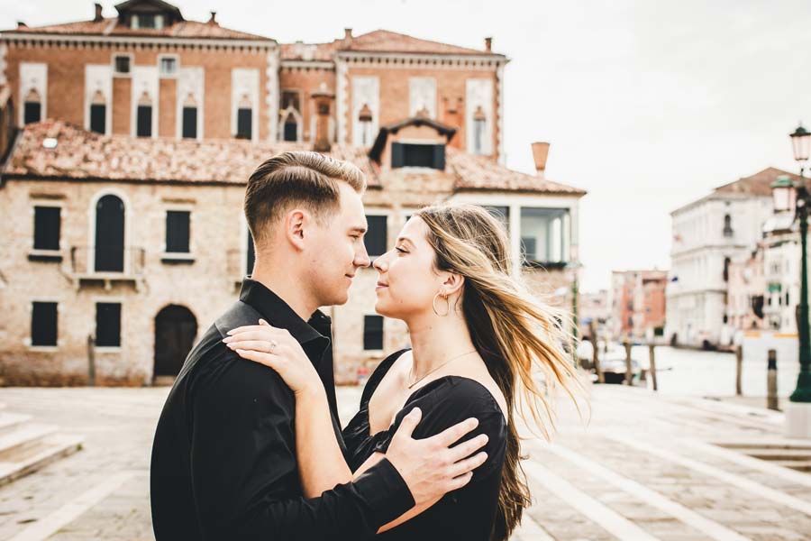 Lovers embracing near the Salute Church at sunset in Venice